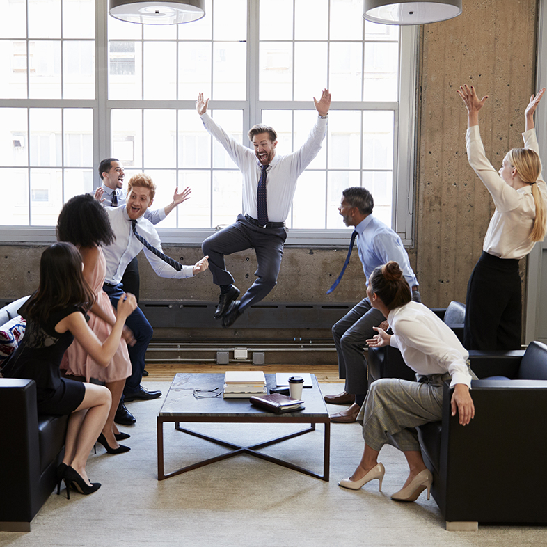 Business team jump for joy at hitting target in meeting Work life balance